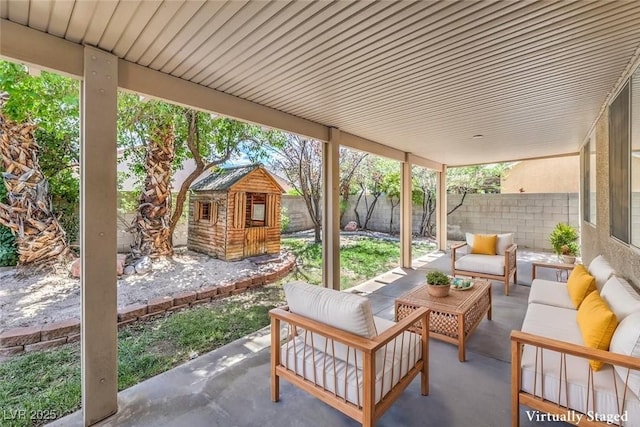 5209 Mantua Ct, Las Vegas, NV 89130 - fenced backyard featuring an outdoor hangout area, a patio area, and a shed