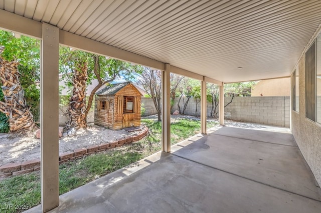 5209 Mantua Ct, Las Vegas, NV 89130 - fenced backyard featuring a patio and an outbuilding