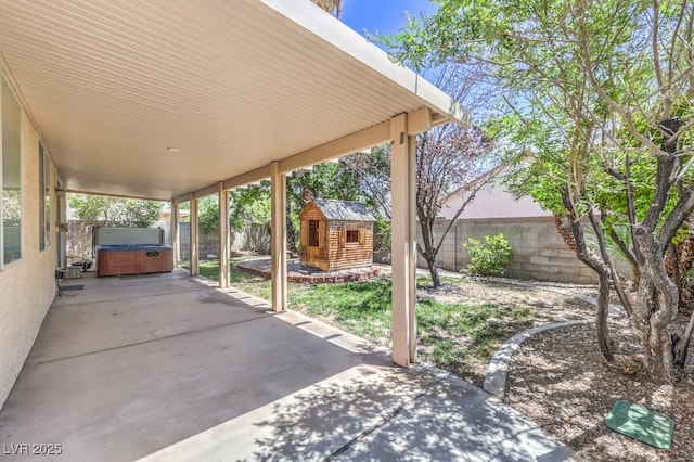 5209 Mantua Ct, Las Vegas, NV 89130 - fenced backyard with a hot tub, a patio area, and an outbuilding