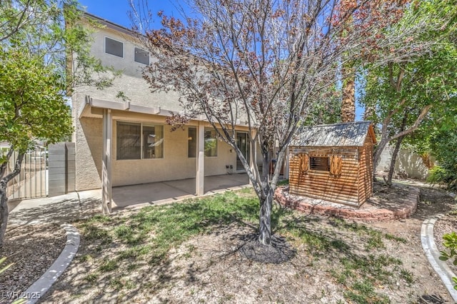 5209 Mantua Ct, Las Vegas, NV 89130 - back of house with stucco siding, a patio area, and a storage shed