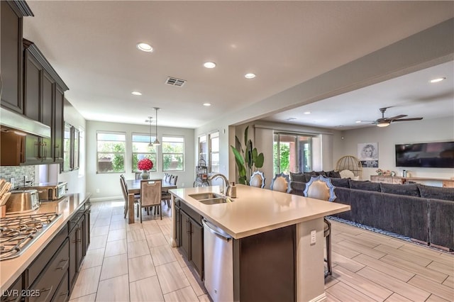 913 Silent Sunset Ave, North Las Vegas, NV 89084 - kitchen with appliances with stainless steel finishes, recessed lighting, open floor plan, light countertops, and tasteful backsplash