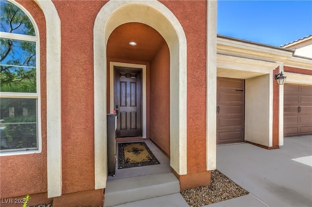 913 Silent Sunset Ave, North Las Vegas, NV 89084 - doorway to property with stucco siding and a garage