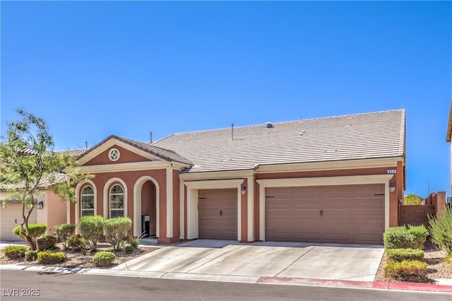 913 Silent Sunset Ave, North Las Vegas, NV 89084 - view of front of home featuring stucco siding, concrete driveway, a garage, and a tile roof