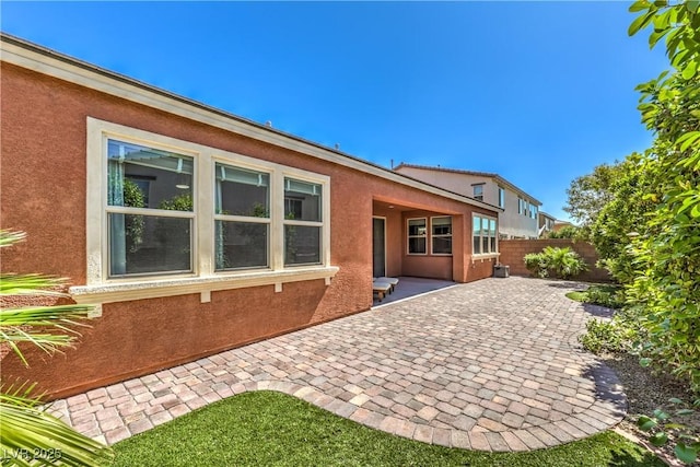 913 Silent Sunset Ave, North Las Vegas, NV 89084 - rear view of property featuring stucco siding and a patio