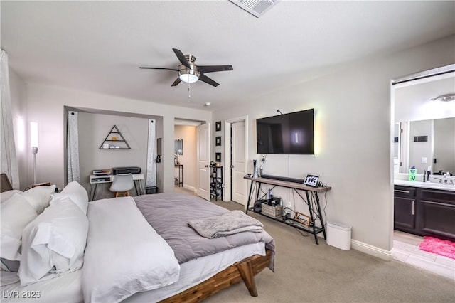 913 Silent Sunset Ave, North Las Vegas, NV 89084 - bedroom with light colored carpet, ensuite bathroom, and ceiling fan