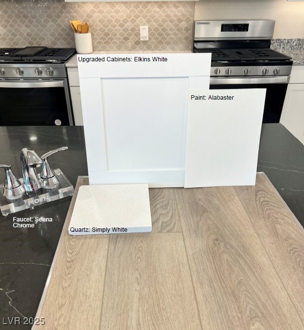 140 Silver Run Ln, Las Vegas, NV 89138 - kitchen featuring stainless steel range with gas stovetop, backsplash, white cabinets, and light countertops
