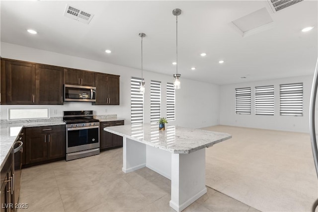 8144 Monsoon Bay St, Las Vegas, NV 89113 - kitchen featuring appliances with stainless steel finishes, dark brown cabinetry, a center island, recessed lighting, and hanging light fixtures