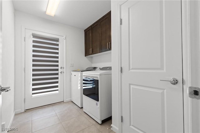 8144 Monsoon Bay St, Las Vegas, NV 89113 - washroom with washer and clothes dryer, cabinet space, and light tile patterned floors