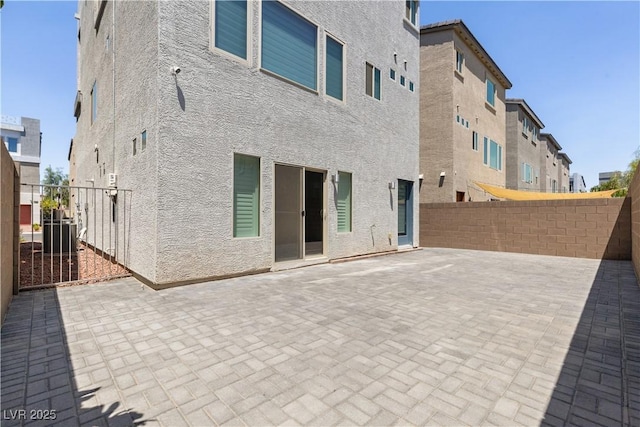 8144 Monsoon Bay St, Las Vegas, NV 89113 - back of property featuring stucco siding and a patio