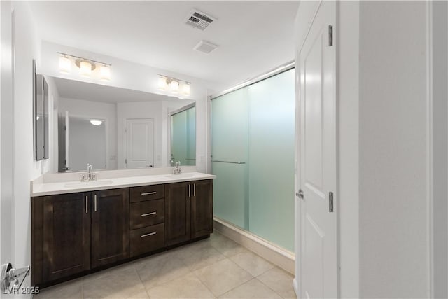 8144 Monsoon Bay St, Las Vegas, NV 89113 - full bathroom with double vanity, a stall shower, and tile patterned floors