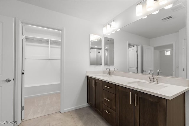 8144 Monsoon Bay St, Las Vegas, NV 89113 - full bathroom with double vanity and tile patterned floors
