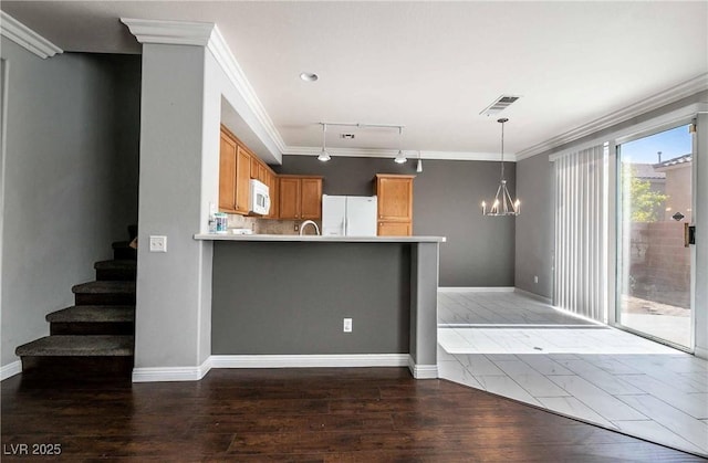 4130 Neighborly Ct, North Las Vegas, NV 89032 - kitchen with white appliances, ornamental molding, a peninsula, light countertops, and a chandelier