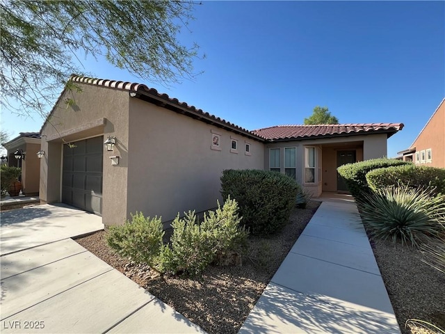 3813 Jasmine Heights Ave, North Las Vegas, NV 89081 - view of property exterior featuring a garage, stucco siding, and a tile roof