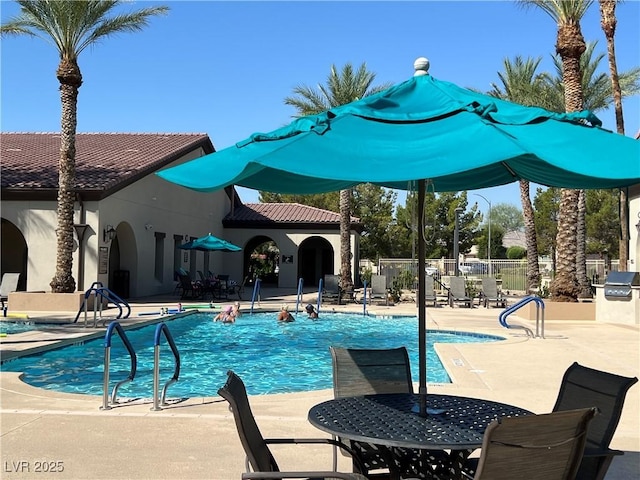 3813 Jasmine Heights Ave, North Las Vegas, NV 89081 - community pool with a patio, an outdoor kitchen, and outdoor dining space