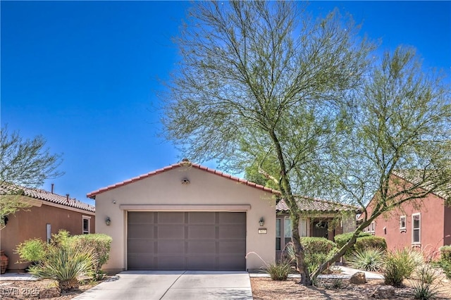 3813 Jasmine Heights Ave, North Las Vegas, NV 89081 - mediterranean / spanish-style home featuring a garage, driveway, stucco siding, and a tiled roof