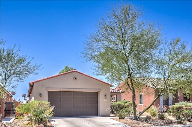 3813 Jasmine Heights Ave, North Las Vegas, NV 89081 - mediterranean / spanish house featuring driveway, an attached garage, stucco siding, and a tiled roof