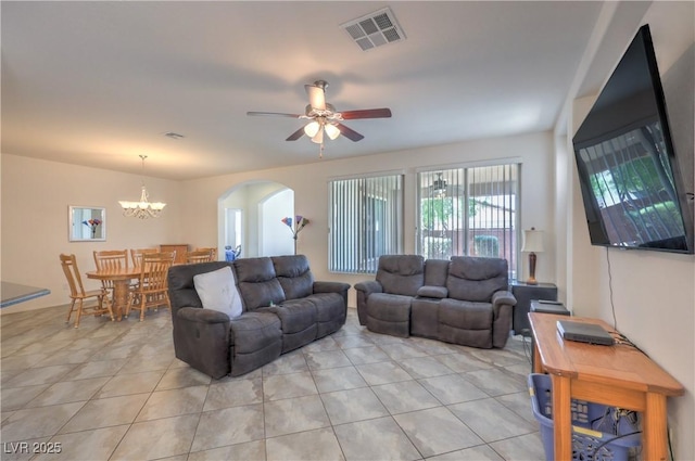 3813 Jasmine Heights Ave, North Las Vegas, NV 89081 - living area with arched walkways, light tile patterned flooring, a ceiling fan, and a chandelier
