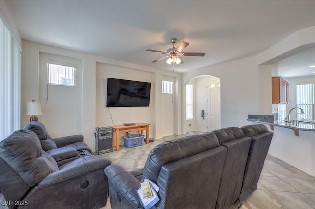 3813 Jasmine Heights Ave, North Las Vegas, NV 89081 - living area with arched walkways, a ceiling fan, and light tile patterned flooring