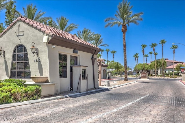 3813 Jasmine Heights Ave, North Las Vegas, NV 89081 - view of front of property with stucco siding, a tiled roof, and uncovered parking