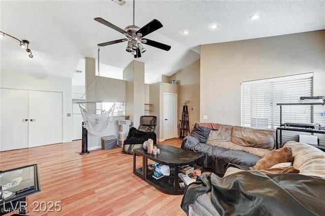 1600 N Torrey Pines Dr Unit 202, Las Vegas, NV 89108 - living room featuring light wood finished floors, ceiling fan, a textured ceiling, and high vaulted ceiling