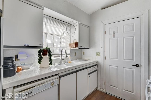 1600 N Torrey Pines Dr Unit 202, Las Vegas, NV 89108 - kitchen featuring white dishwasher, white cabinetry, tile counters, and dark wood-type flooring