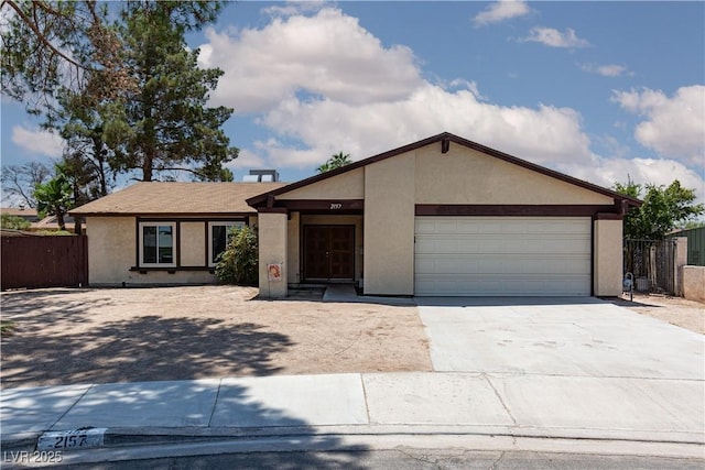 2157 Mccoig Ave, Las Vegas, NV 89119 - ranch-style house with stucco siding, driveway, and an attached garage