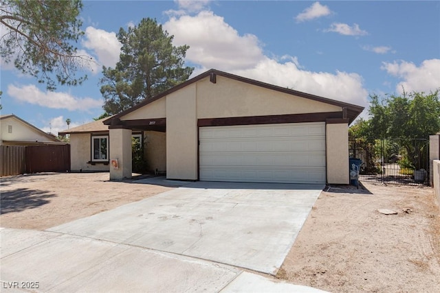 2157 Mccoig Ave, Las Vegas, NV 89119 - view of front facade featuring stucco siding, concrete driveway, and a garage