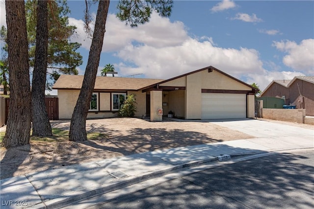2157 Mccoig Ave, Las Vegas, NV 89119 - ranch-style house featuring stucco siding, concrete driveway, and an attached garage