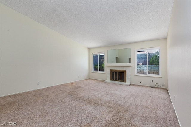 2157 Mccoig Ave, Las Vegas, NV 89119 - unfurnished living room featuring healthy amount of natural light, a textured ceiling, light colored carpet, and a brick fireplace
