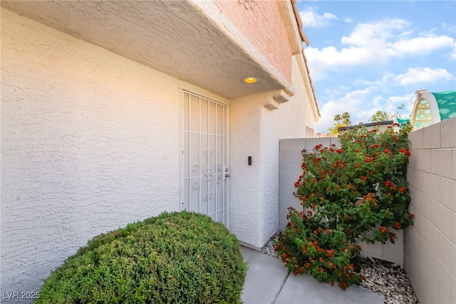 7048 Harbor View Dr, Las Vegas, NV 89119 - doorway to property featuring stucco siding