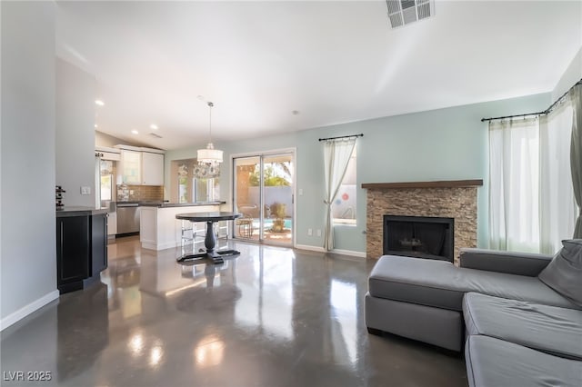 7048 Harbor View Dr, Las Vegas, NV 89119 - living area with finished concrete floors, a chandelier, a stone fireplace, lofted ceiling, and recessed lighting