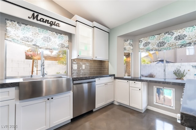 7048 Harbor View Dr, Las Vegas, NV 89119 - kitchen with stainless steel dishwasher, finished concrete floors, backsplash, and white cabinets