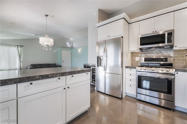 7048 Harbor View Dr, Las Vegas, NV 89119 - kitchen featuring appliances with stainless steel finishes, backsplash, white cabinetry, and a chandelier