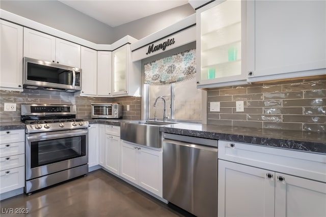 7048 Harbor View Dr, Las Vegas, NV 89119 - kitchen featuring appliances with stainless steel finishes, decorative backsplash, and glass insert cabinets