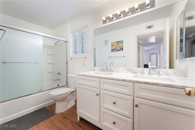 5259 Caspian Springs Dr Unit 204, Las Vegas, NV 89120 - full bathroom featuring double vanity, wood finished floors, and shower / bath combination with glass door