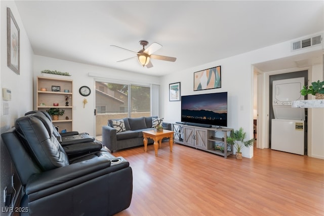 5259 Caspian Springs Dr Unit 204, Las Vegas, NV 89120 - living room with estacked washer and dryer, light wood-type flooring, and a ceiling fan