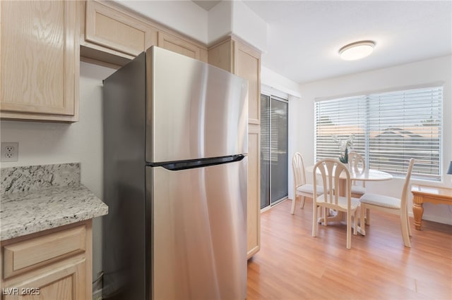 5259 Caspian Springs Dr Unit 204, Las Vegas, NV 89120 - kitchen with freestanding refrigerator, light brown cabinets, light wood-style floors, and light stone counters