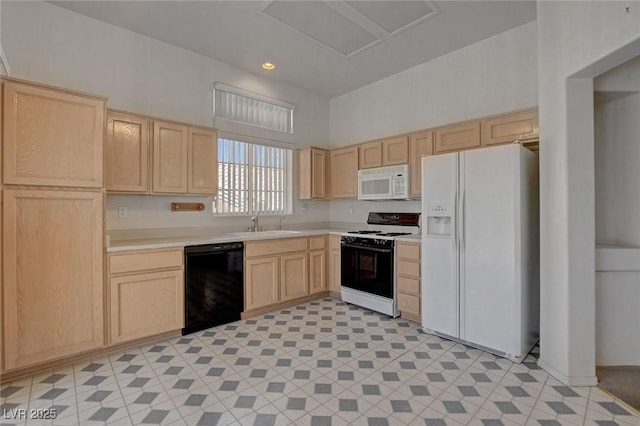 10724 Windledge Ave, Las Vegas, NV 89134 - kitchen with white appliances, light brown cabinetry, light countertops, light floors, and recessed lighting