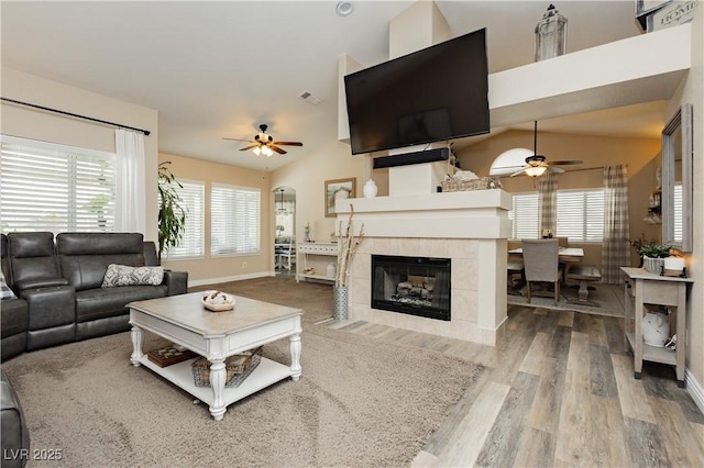 4813 W Virginia Falls Ln, Las Vegas, NV 89130 - living room with a ceiling fan, wood finished floors, healthy amount of natural light, a tile fireplace, and lofted ceiling