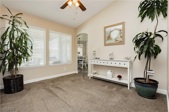 4813 W Virginia Falls Ln, Las Vegas, NV 89130 - living area featuring a ceiling fan, lofted ceiling, carpet, and arched walkways