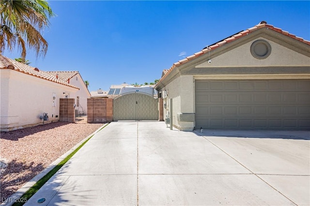 4813 W Virginia Falls Ln, Las Vegas, NV 89130 - view of side of home with a gate, concrete driveway, a tiled roof, and stucco siding