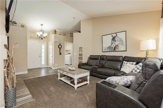 4813 W Virginia Falls Ln, Las Vegas, NV 89130 - living area with a chandelier, washer / clothes dryer, wood finished floors, and high vaulted ceiling