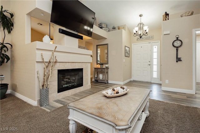 4813 W Virginia Falls Ln, Las Vegas, NV 89130 - living room featuring a chandelier, a tile fireplace, wood finished floors, and carpet floors