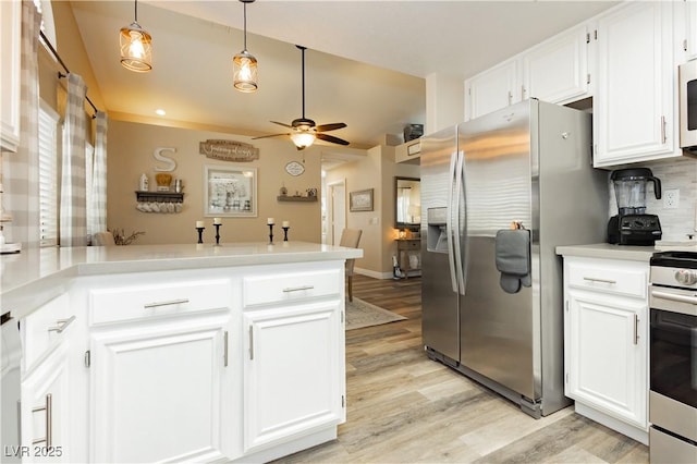4813 W Virginia Falls Ln, Las Vegas, NV 89130 - kitchen with appliances with stainless steel finishes, a peninsula, light wood-type flooring, ceiling fan, and light countertops