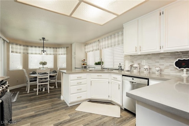 4813 W Virginia Falls Ln, Las Vegas, NV 89130 - kitchen with appliances with stainless steel finishes, white cabinetry, light wood-type flooring, light countertops, and backsplash