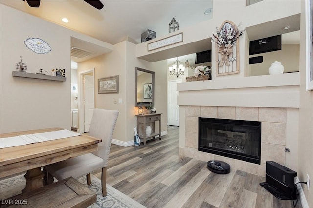 4813 W Virginia Falls Ln, Las Vegas, NV 89130 - dining room with wood finished floors, a ceiling fan, a fireplace, and recessed lighting