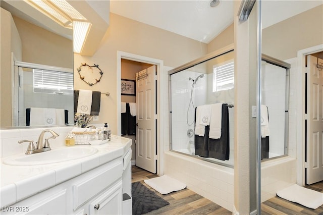 4813 W Virginia Falls Ln, Las Vegas, NV 89130 - bathroom featuring wood finished floors, double vanity, and tiled shower / bath