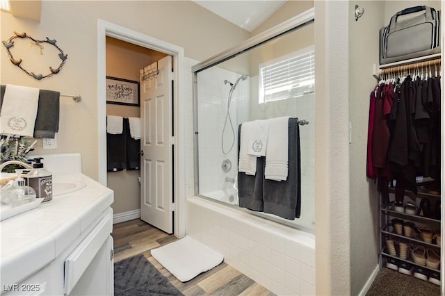 4813 W Virginia Falls Ln, Las Vegas, NV 89130 - bathroom featuring tiled shower / bath combo, wood finished floors, vanity, and a spacious closet