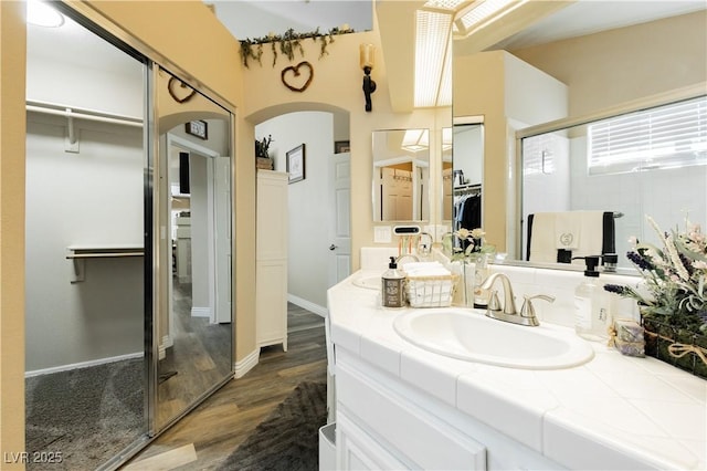 4813 W Virginia Falls Ln, Las Vegas, NV 89130 - full bath featuring a spacious closet, vanity, wood finished floors, and a stall shower