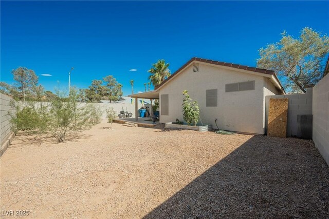 6552 Sweetzer Way, Las Vegas, NV 89108 - rear view of property with stucco siding, a fenced backyard, and a patio